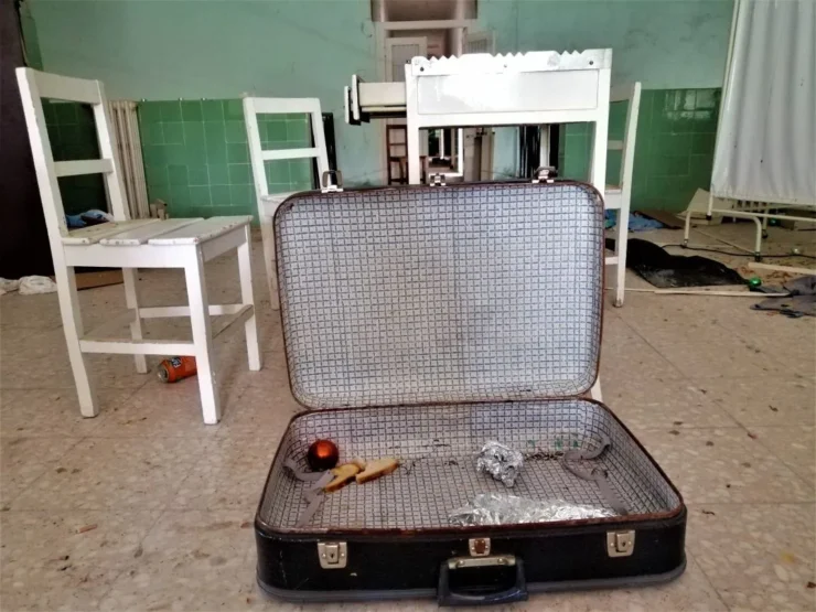 Maleta con restos de comida y sillas de fondo en el Instituto Leprológico Nacional de Trillo. Leprosería de Trillo, un lugar de curación vuelto ruina