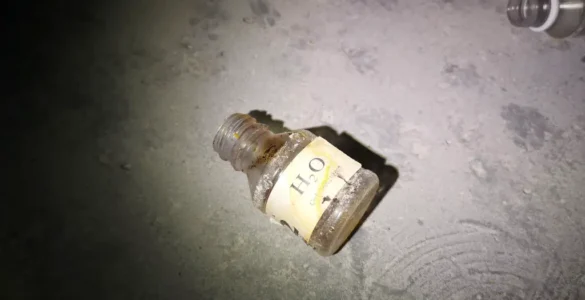 Un bote abierto de H2O en el suelo del sótano de la Piscina de Pesués